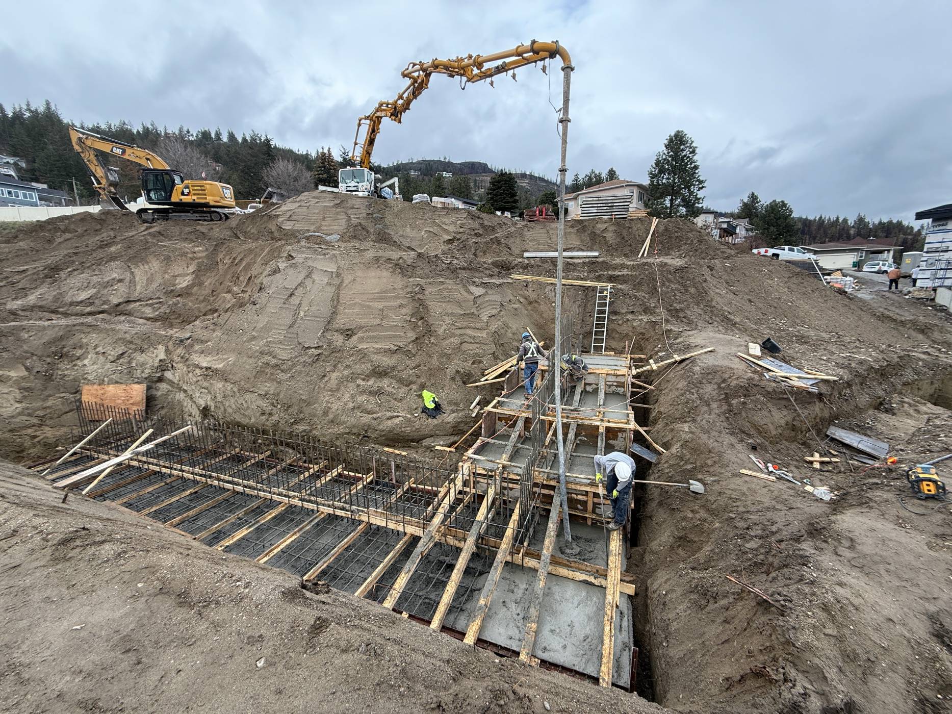Construction site with machinery and workers.