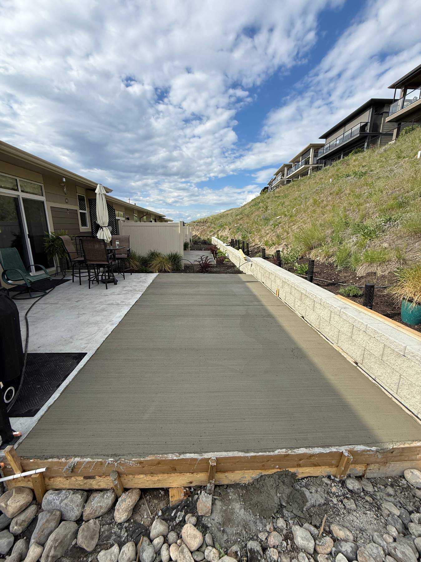 Concrete patio with cloudy sky backdrop.