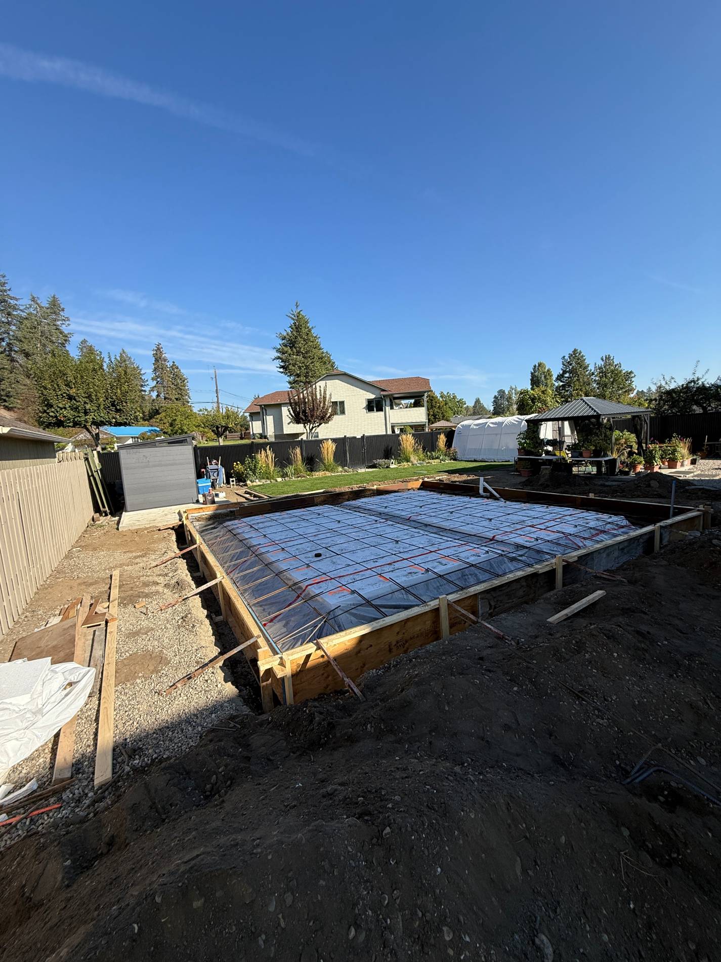 Construction site with concrete foundation and framework.