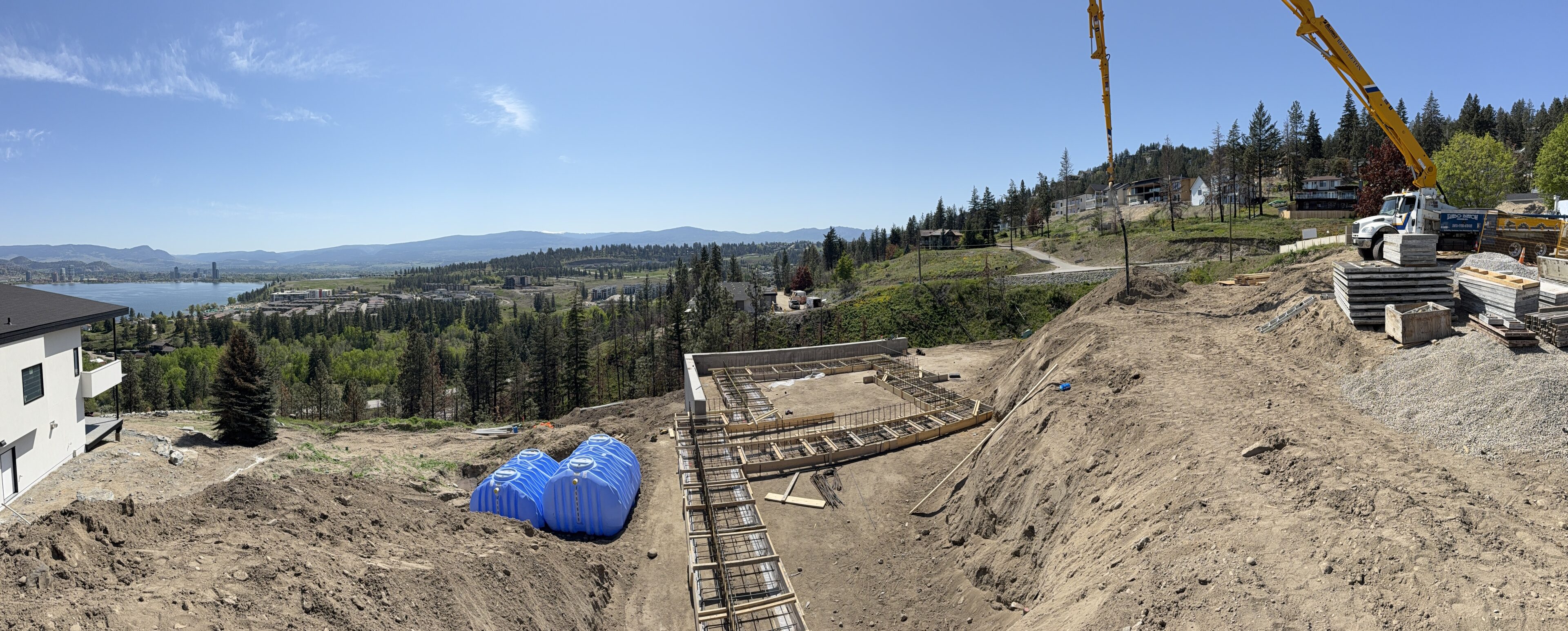 Construction site with cranes and scenic view.