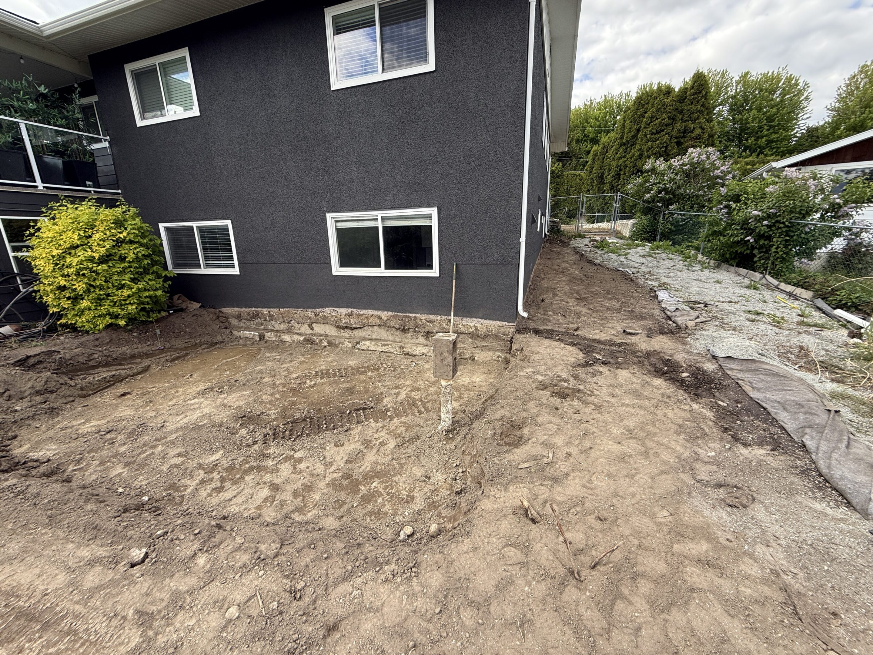 House exterior with dirt landscaping renovation.