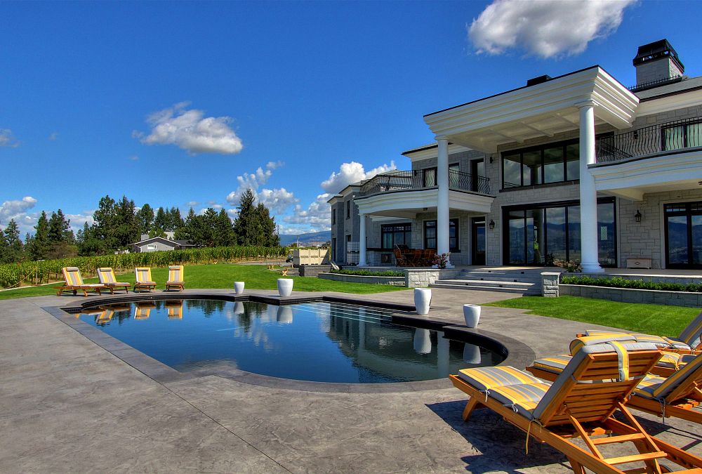 Luxury house with pool and sun loungers.