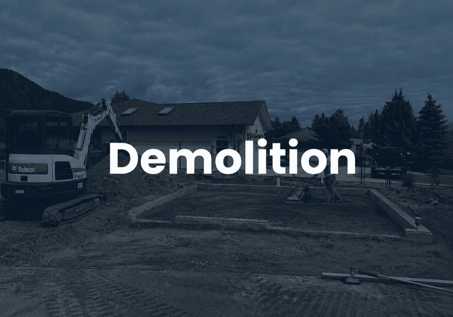 House demolition with excavator and debris.